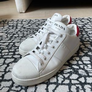 White Prada Sneakers w/red heel tab. W10